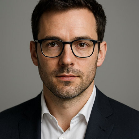 Portrait of a handsome man in a suit and glasses on a gray background