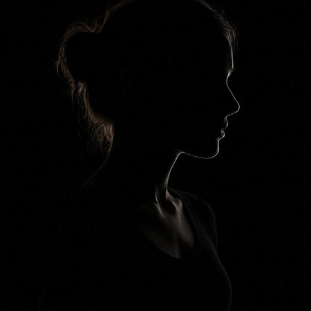 Silhouette of a beautiful young girl on a black background.