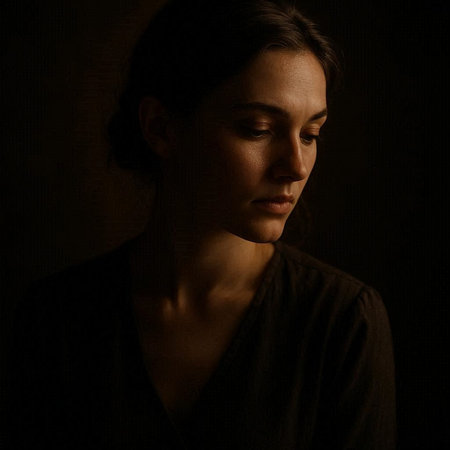 Portrait of a sad young woman on dark background. Studio shot.