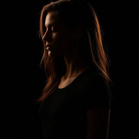 Portrait of a beautiful young woman on a black background. Studio shot.