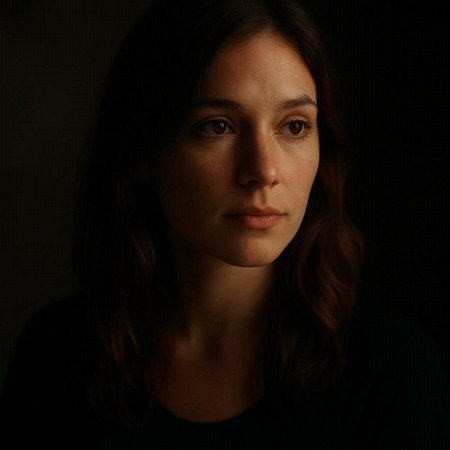 Portrait of a young woman with long hair on a dark background