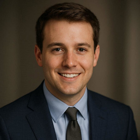Portrait of a handsome young businessman smiling at the camera in a suit