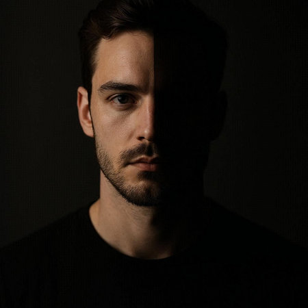 Portrait of a handsome man with a beard in a dark room