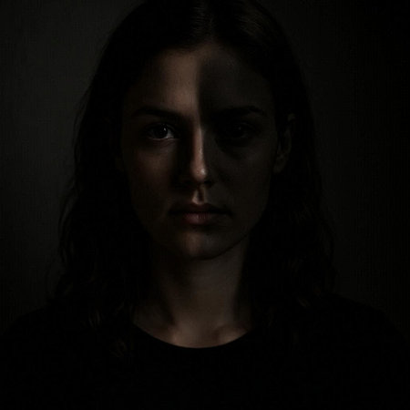 Portrait of a young woman with long hair in a dark room