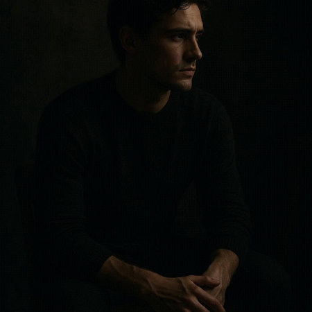 Portrait of a handsome man in a black sweater on a dark background