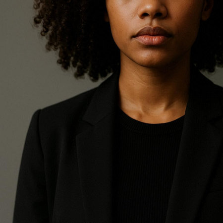 Close up portrait of a young african american woman in a black jacketの写真素材