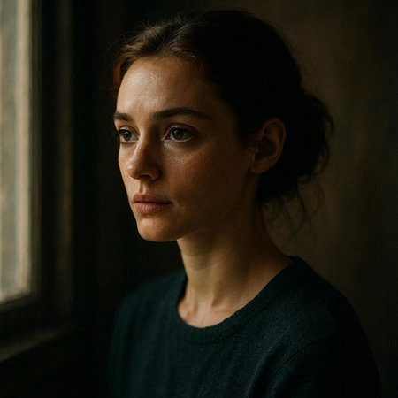 Portrait of a young woman in a dark room with a window