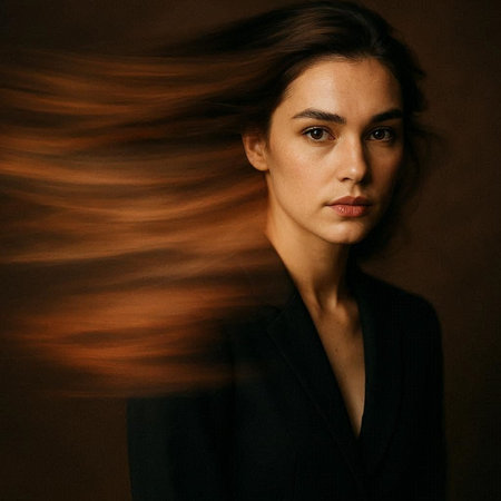 Portrait of a beautiful young woman with flying hair on a dark backgroundの写真素材
