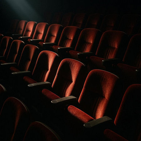 Cinema auditorium with red seats and spotlight. Cinema background