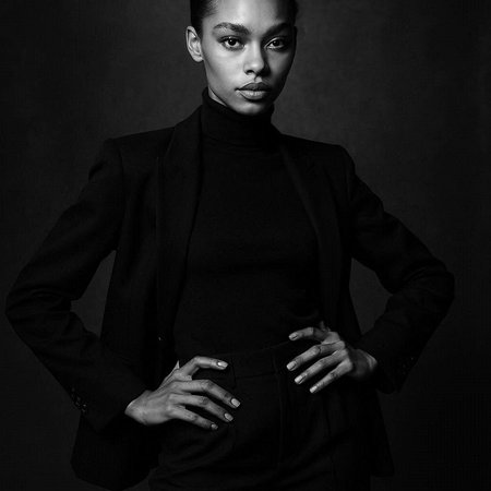 Black and white portrait of beautiful young african american woman in black suit