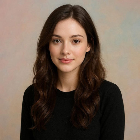 Portrait of a beautiful young woman with long brown hair on a gray background