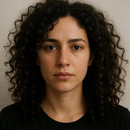 Portrait of a young woman with curly hair looking at the camera