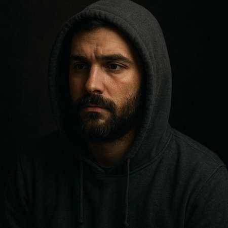 Portrait of a bearded man in a hood on a dark background