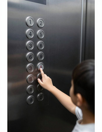 Woman pressing elevator button on the elevator door. Focus on hand.
