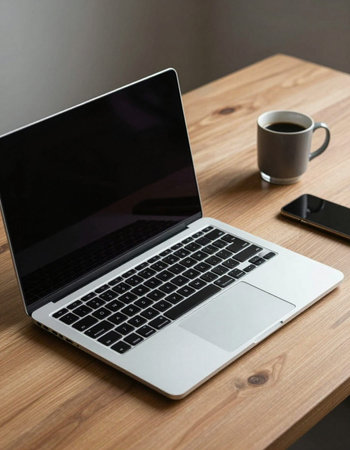 Laptop and coffee cup on the wooden table with copy space.