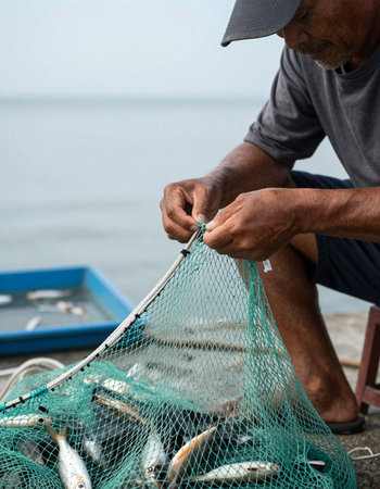 Fisherman catch fish on the fishing boat at the sea.