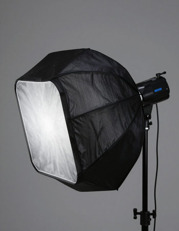 Photo studio equipment on grey background. Softbox and strobe lights