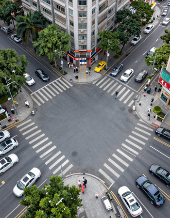 Aerial view of Hong Kong city with crosswalk and traffic.