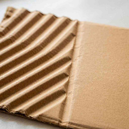Brown corrugated cardboard sheet useful as a background, soft focus