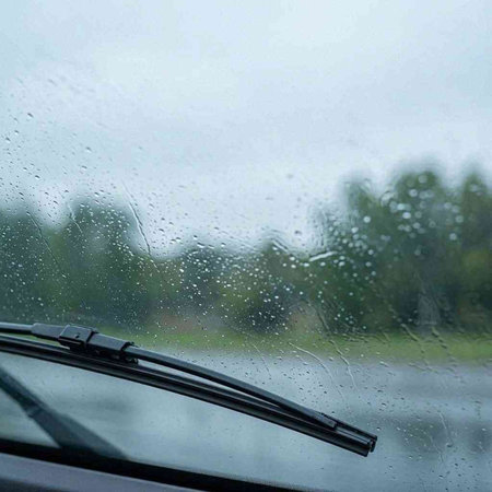 Raindrops on the windshield of a car. Rainy day.