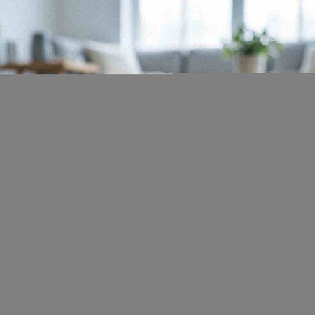 Close-up of a woman sitting at a table in the living room