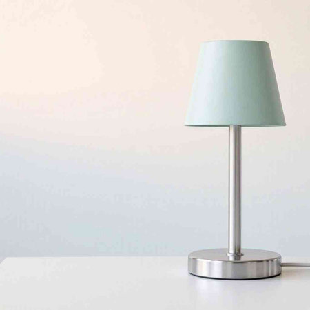 Table lamp on white table. Minimalist interior design concept.