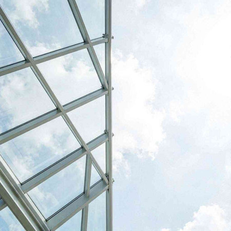modern office building with glass roof and blue sky. abstract background.