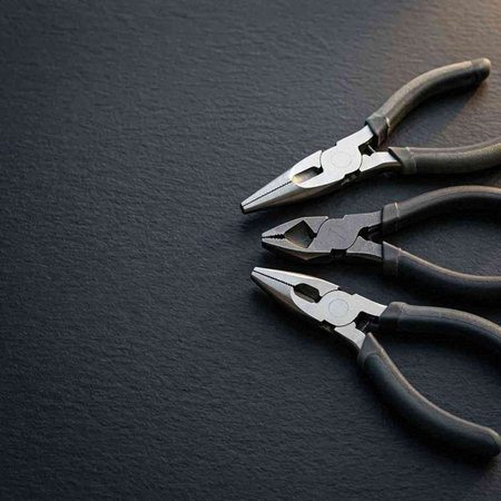 Pliers on a black background. Top view. Copy space.