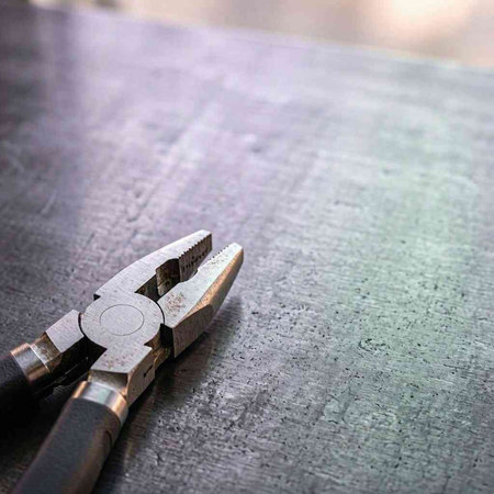Close up of pliers on a table. Selective focus.