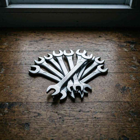 Spanners on the wooden floor in front of the window. Black and white photo.