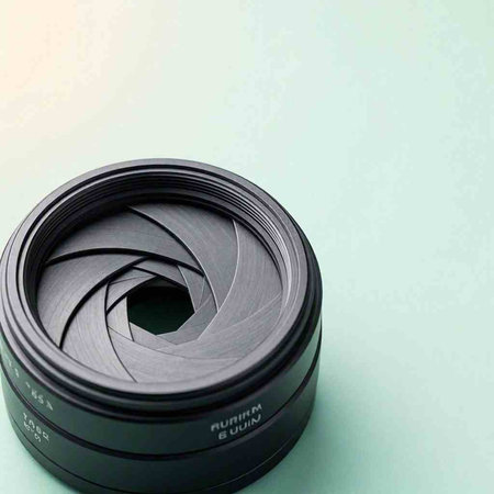 Camera lens isolated on a white background. Close-up photo.