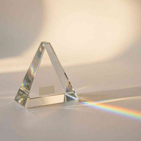 3d render of a glass pyramid with a rainbow in the background