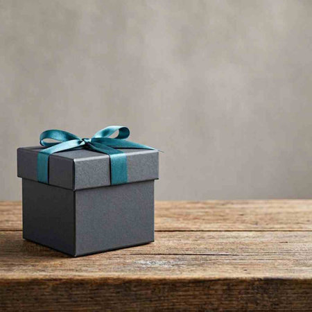 Gift box with blue ribbon on wooden table over grunge background