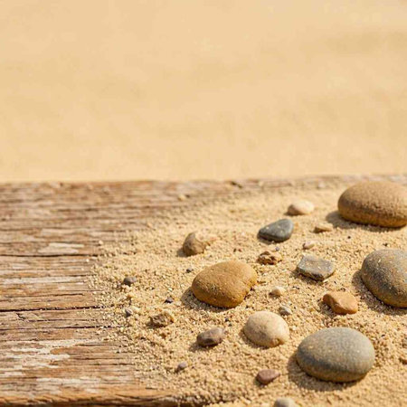 Stones on the beach with sand as a background and copy space