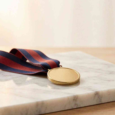 St. George ribbon and gold medal on a marble countertop.