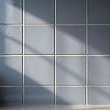 White tile wall with shadow from the window. Texture for design.