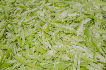 Fresh green bell pepper sliced for cooking.