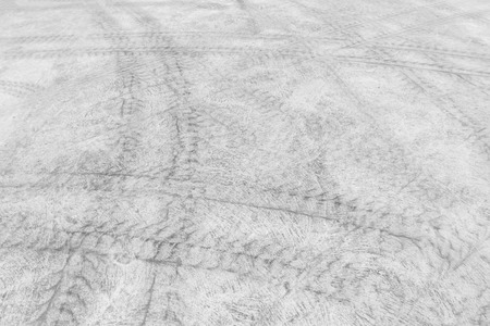 Background turbulent abstract with blur tire tracks and footstep on the street.の写真素材