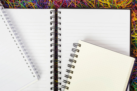 Blank spiral notepad notebooks on electric wire.の写真素材