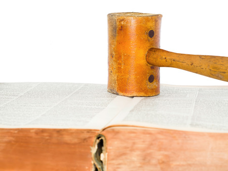 Leather hammer on a old thick book.の写真素材