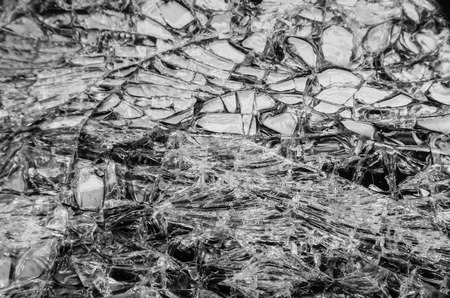 LED of smartphone has a badly damaged screen with spiderweb cracks, selective focus.の写真素材