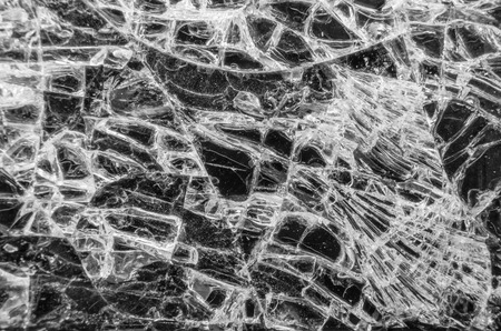 LED of smartphone has a badly damaged screen with spiderweb cracks, selective focus.の写真素材