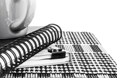 Hot Coffee Cup and Notebook on Wooden Mat with black and white photography and selective focus.の写真素材