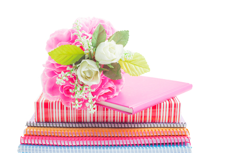 Plastic bouquet on a lovely gift and notebook isolated on white background.の写真素材