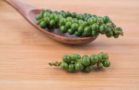 pepper corns on wooden tableの写真素材