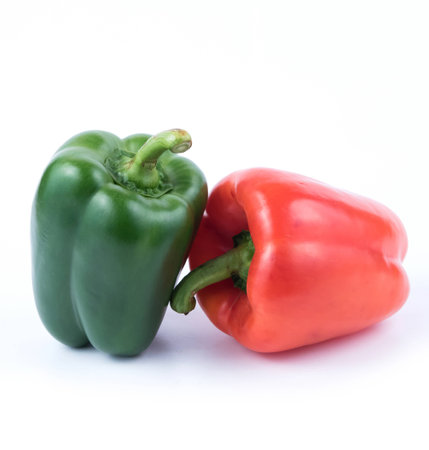 Green and red pepper on white background