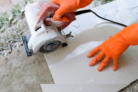 Man with grinder cutting a granito tileの写真素材
