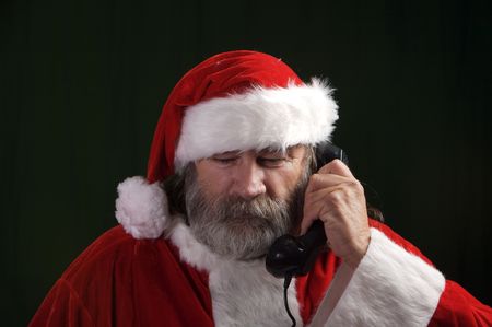 A young Santa with gray hair and beard having a good time