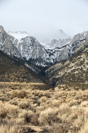 Mt. Whitney shrouded in clouds during winterの写真素材