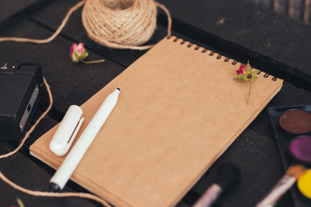 Cozy blank a4 sheet mockup, Blank paper with artist brushes on wooden table with cup and camera